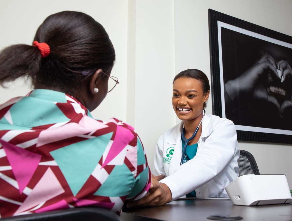 About A smiling doctor in a white coat checks a patient's blood pressure at German Ozone Medical Centre.