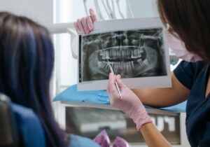 Dental implant procedure showing titanium post placement in jawbone.