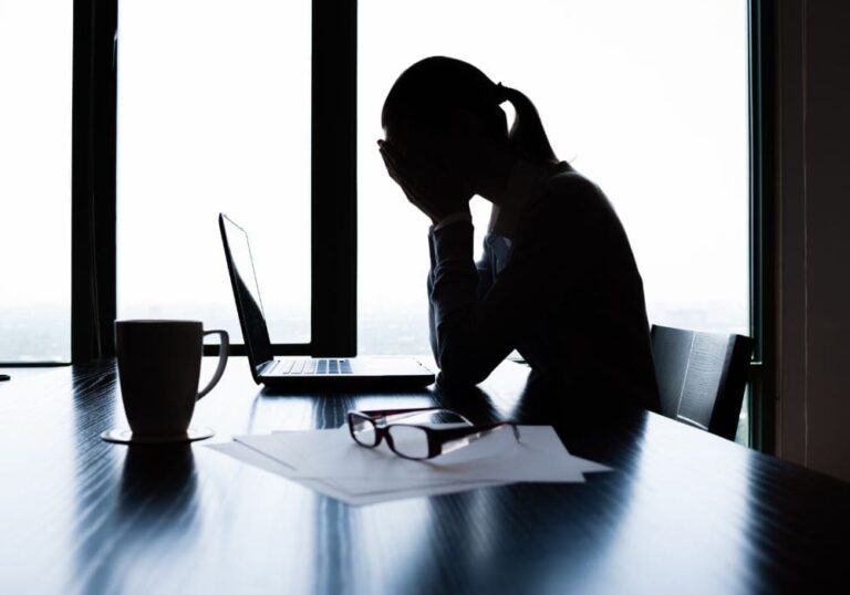 Ozone Therapy for Stress Relief: How It Helps the Mind and Body Heal Stressed woman at work with head in hands, showing fatigue — ozone therapy can help reduce stress and improve well-being.